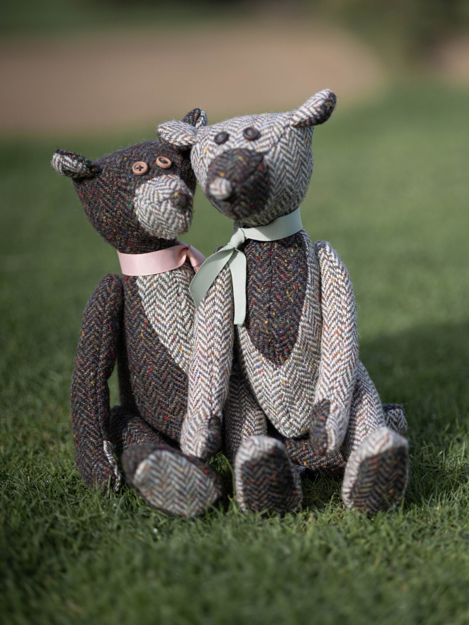 Two decorative fabric companions on a wooden bench
